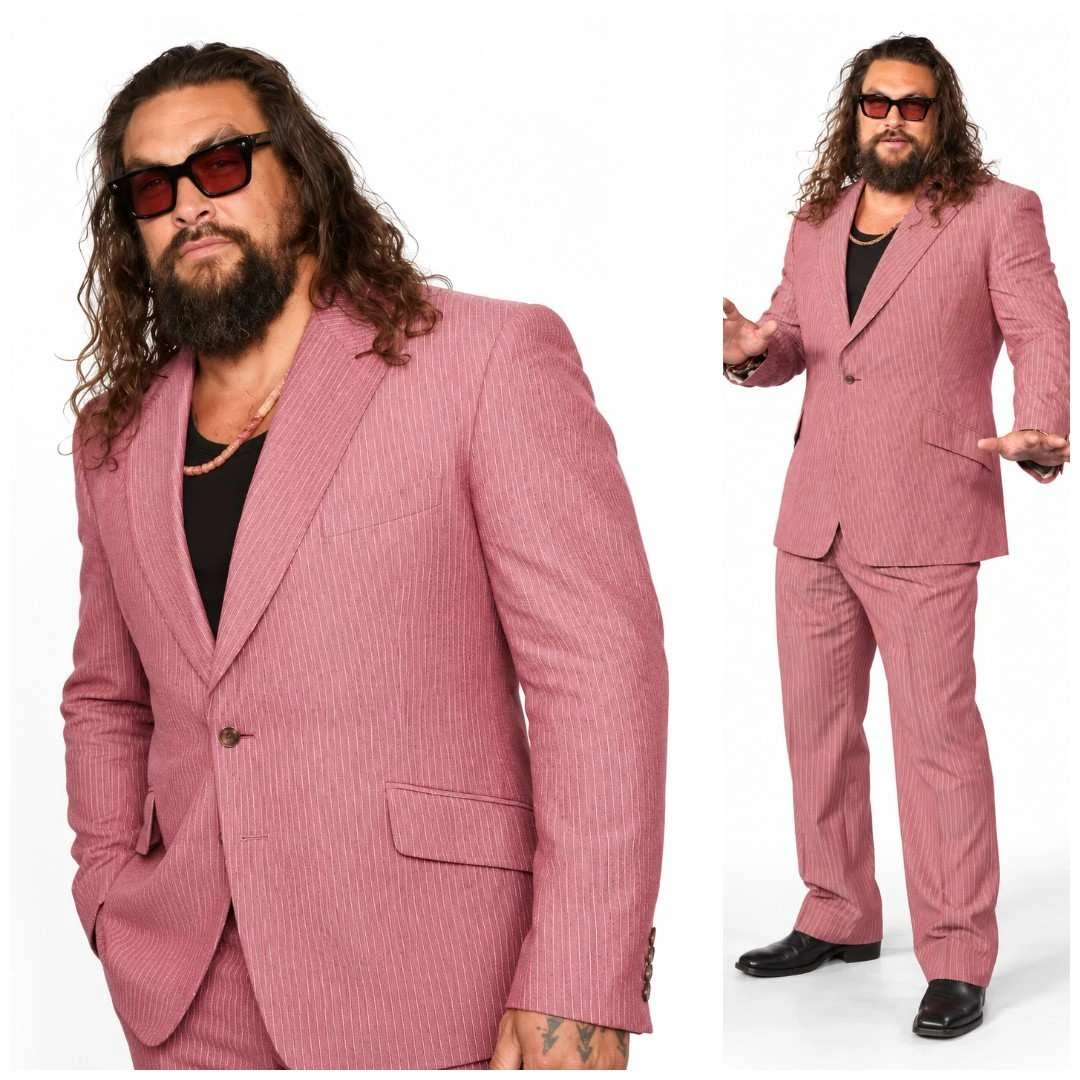 Jason Momoa wearing a pink pinstripe suit with matching trousers